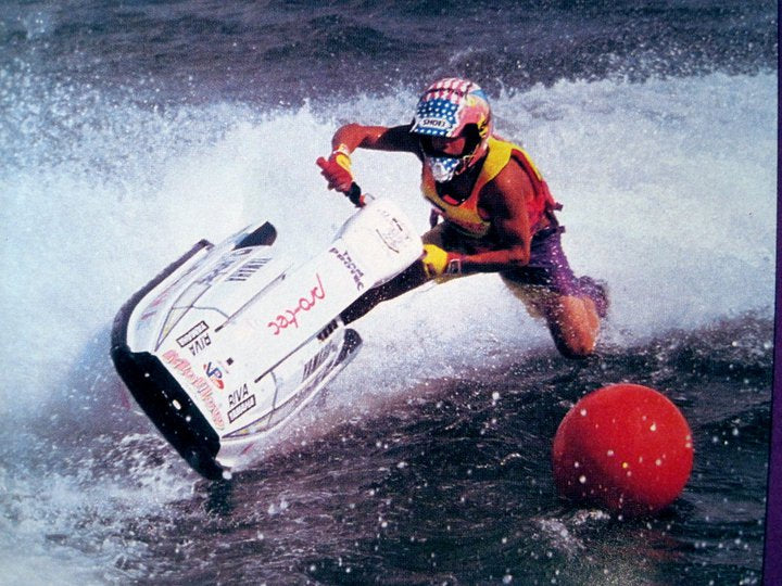 Dynamic rider on a Yamaha WaveRunner carving through waves near a buoy, showcasing excitement and performance - Yamaha Vintag